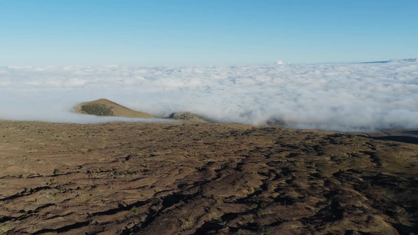 Mountains rise above the clouds