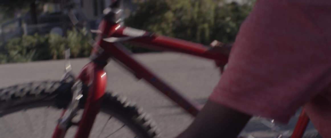 A boy fixes his bike tires