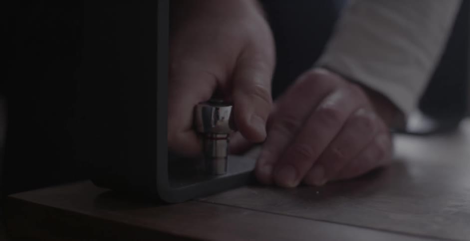 A man adjusts a bolt with a ratchet