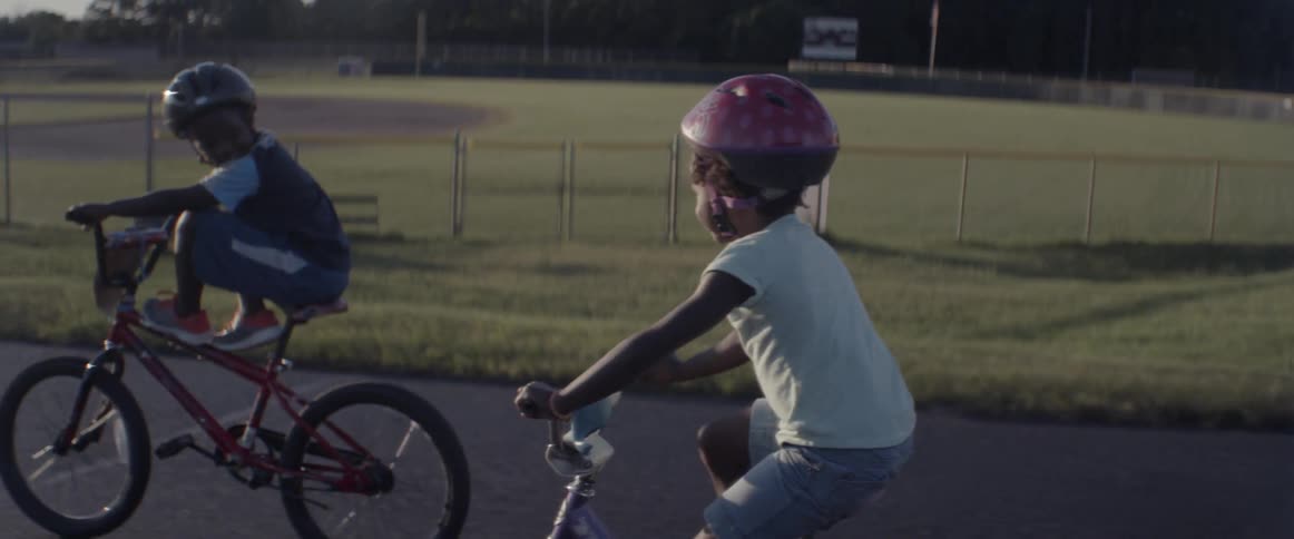 Children ride their bikes in the street