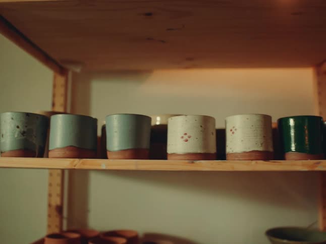 A row of ceramic pots on a shelf