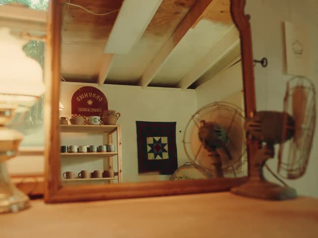 The woman walks past the mirror