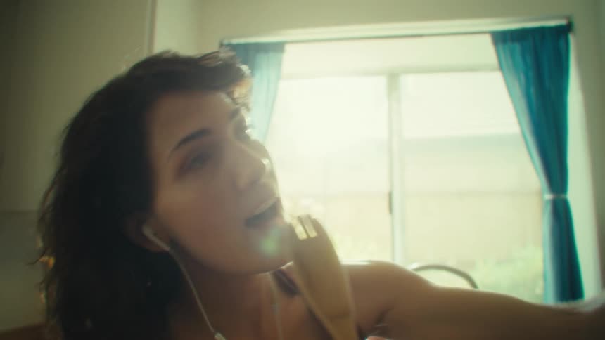 Woman singing with a wooden spoon
