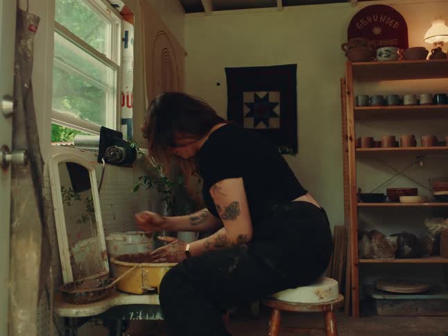 Woman working with clay in a room