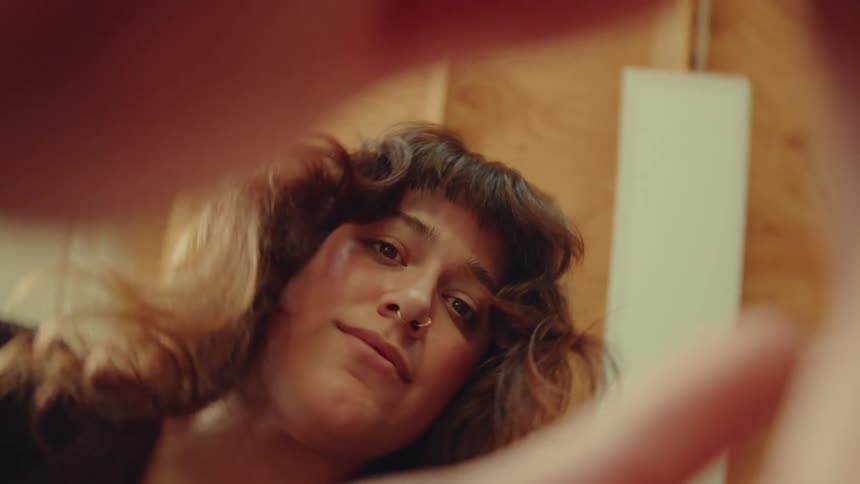 Woman looks downward intently with a thoughtful expression