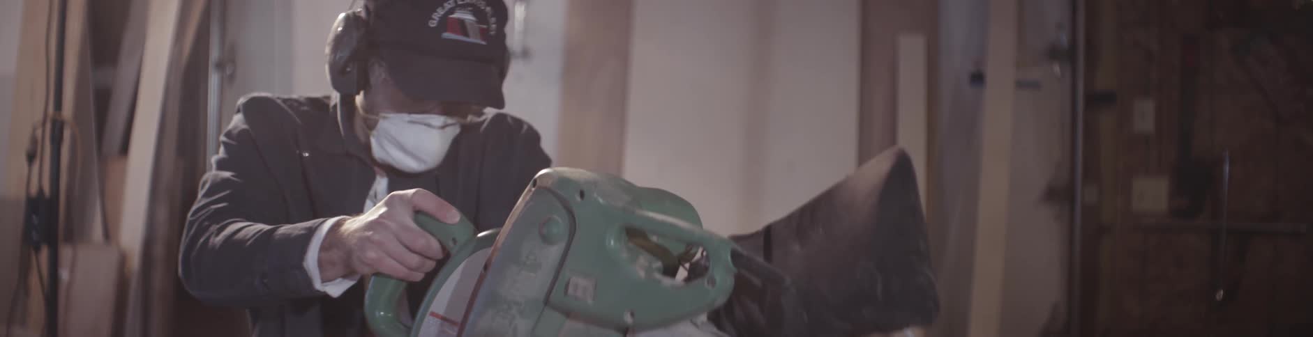A man cuts lumber with a table saw