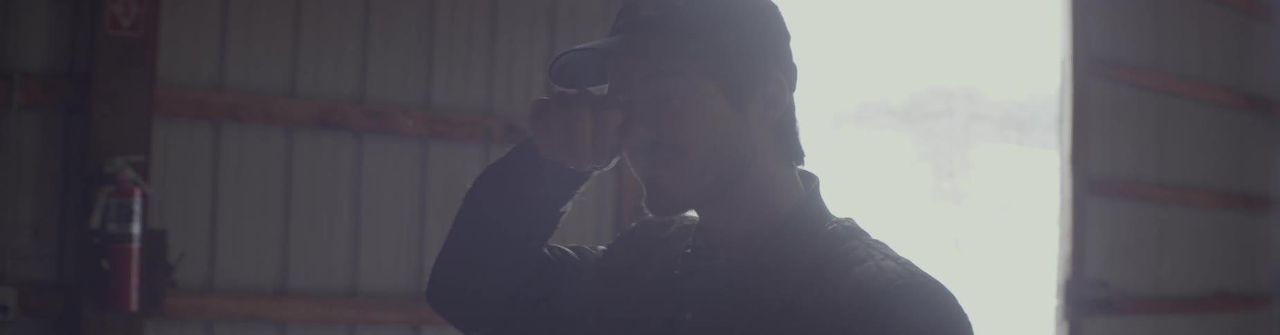 A man walks through a dark warehouse