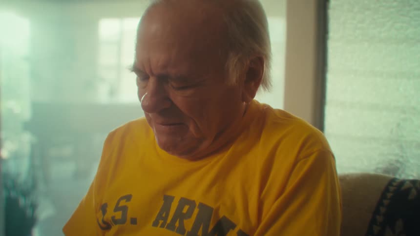 Elderly man wears a yellow shirt