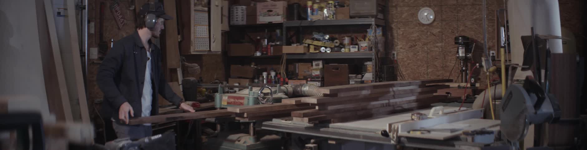 A man inspects a piece of lumber