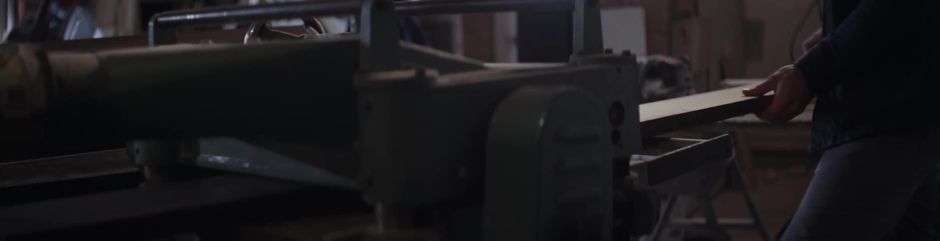 A piece of lumber is fed through a machine