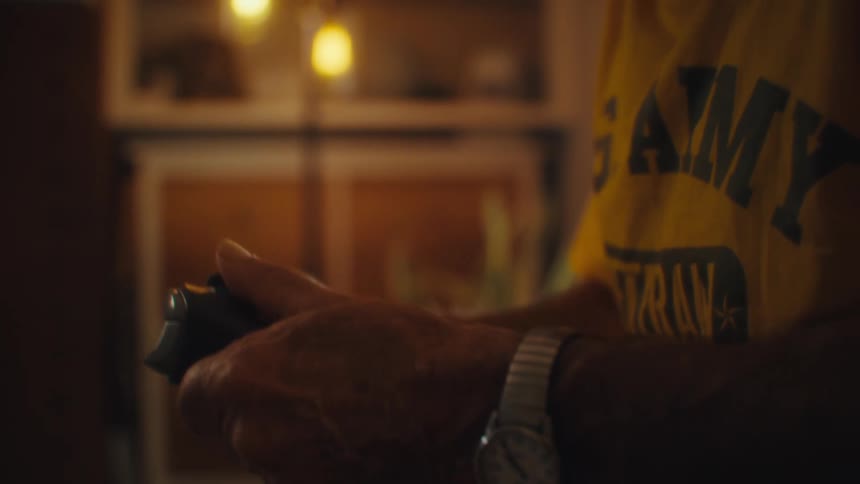 Mans hands with a wristwatch hold a video game controller