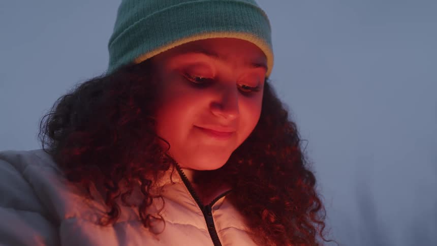Light shines on the girls face outside