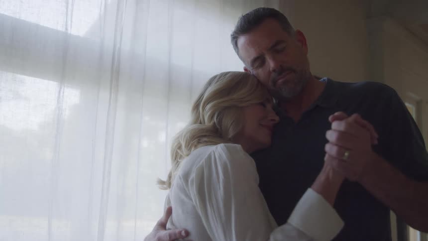 Husband and wife dancing at home