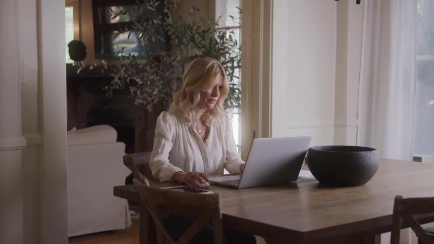 The woman is typing on her laptop