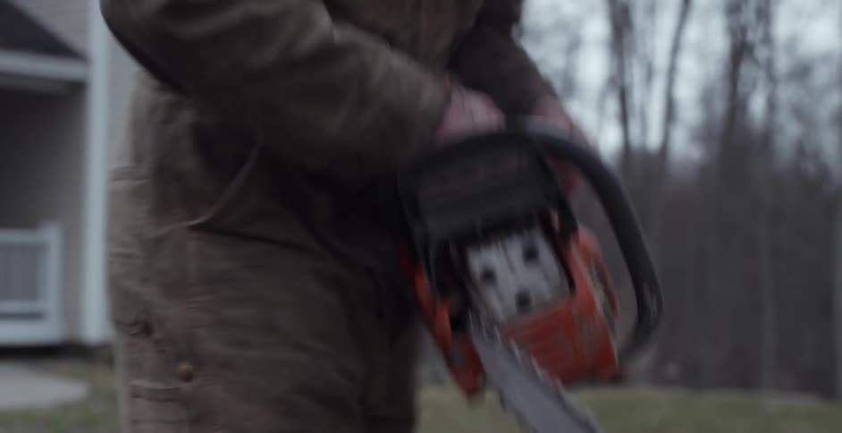 A man starts a chainsaw