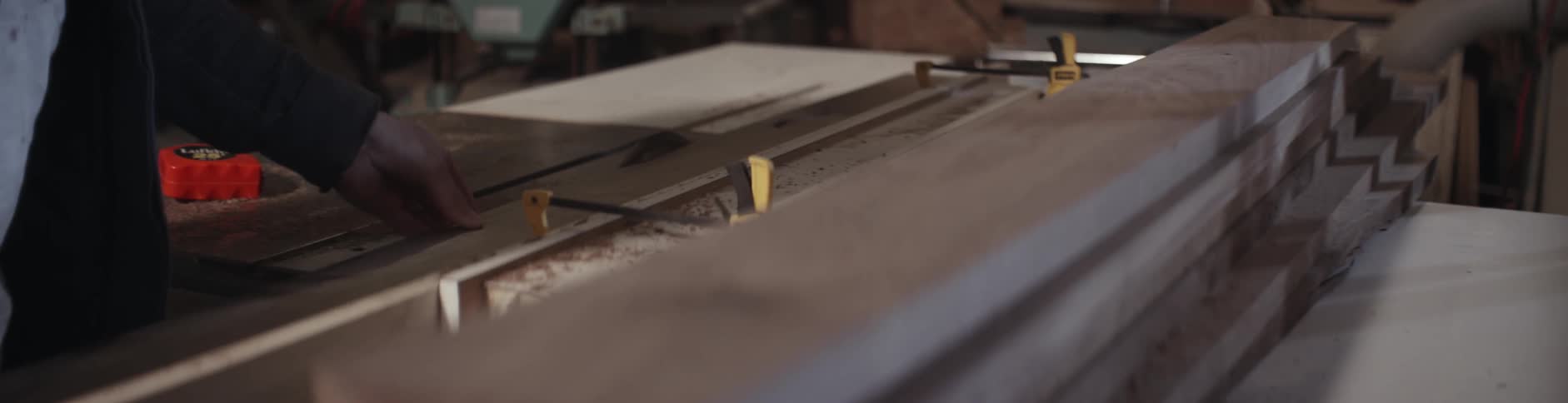 A man cuts a piece of wood