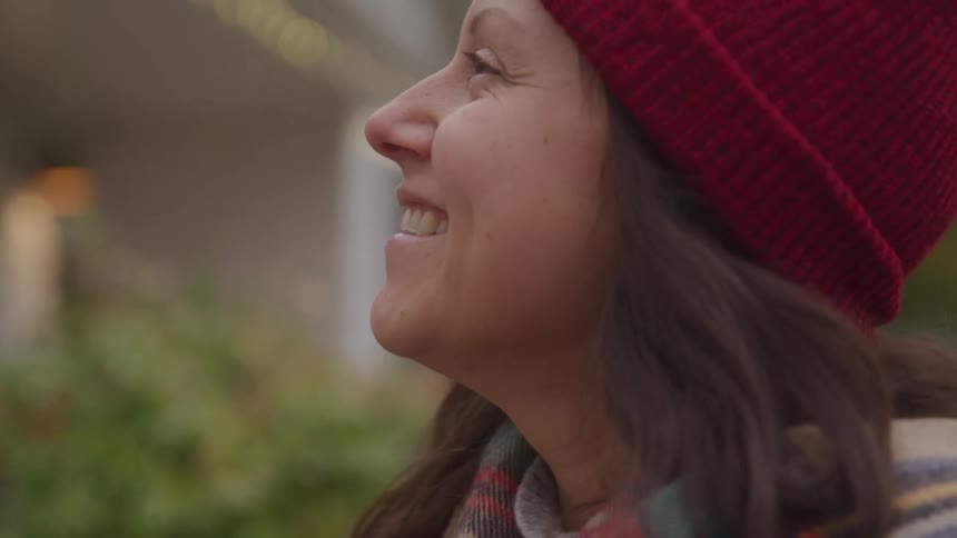 Close up portrait of a young woman speaking while standing outdoors during daytime