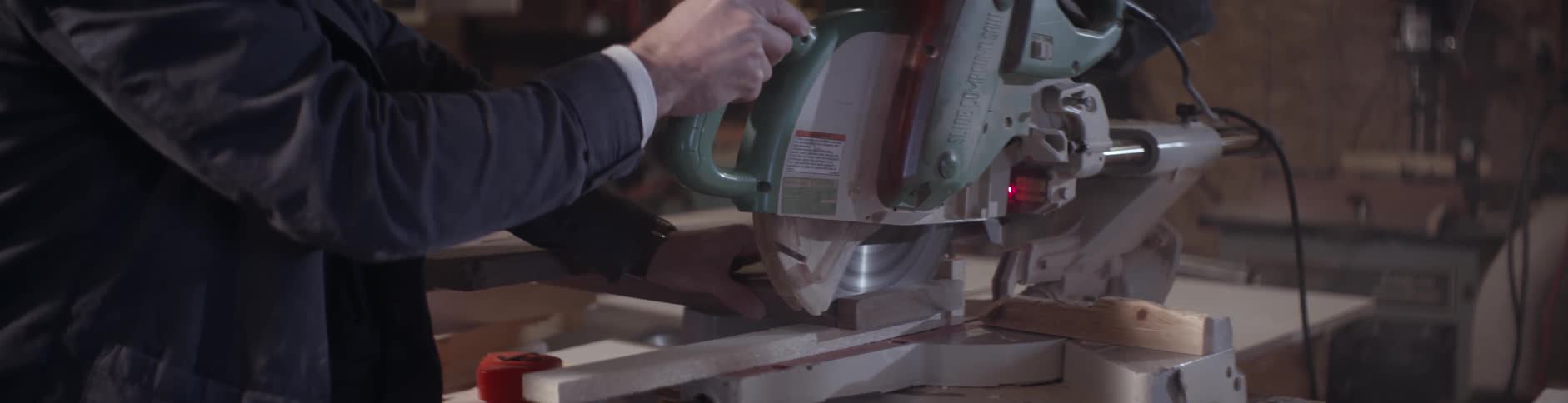 A man saws a piece of wood