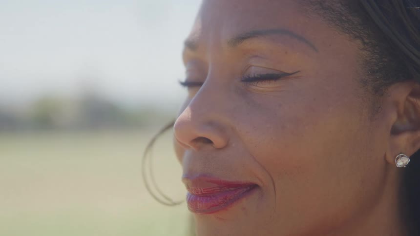 A woman is smiling and blinking her eyes