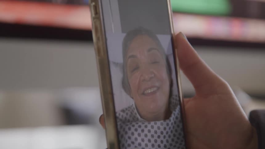 Person joins a video call smiling on a cellphone screen
