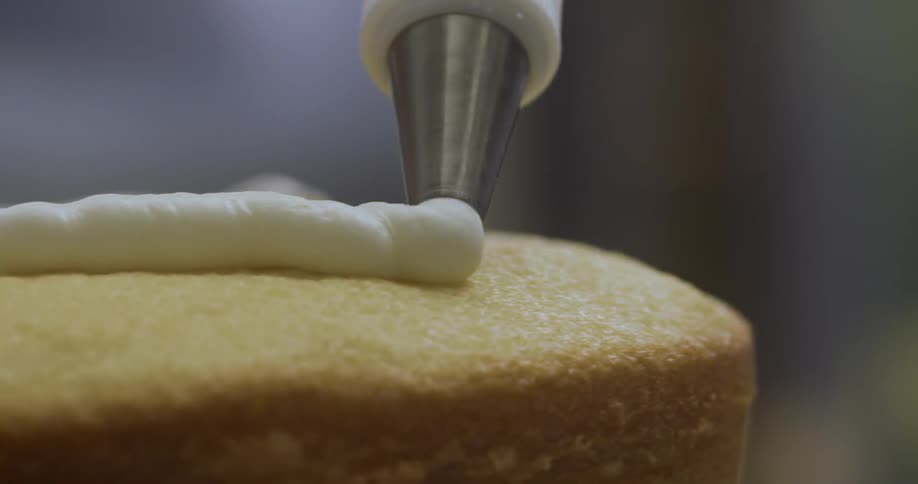 Icing is being put on a cake