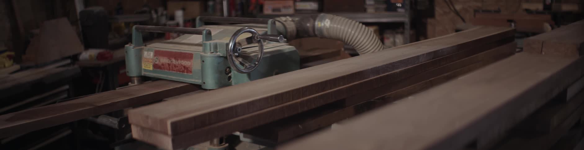 A piece of wood is pushed through a machine