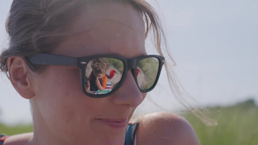 Smiling woman wears sunglasses