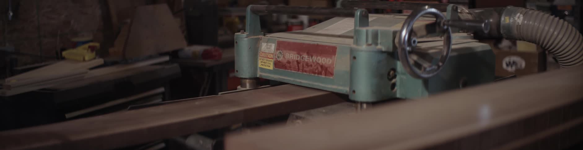 A board is being pushed through a machine