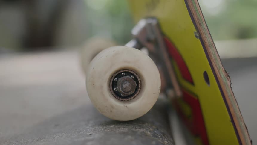 White skateboard wheel in closeup on a ramp surface