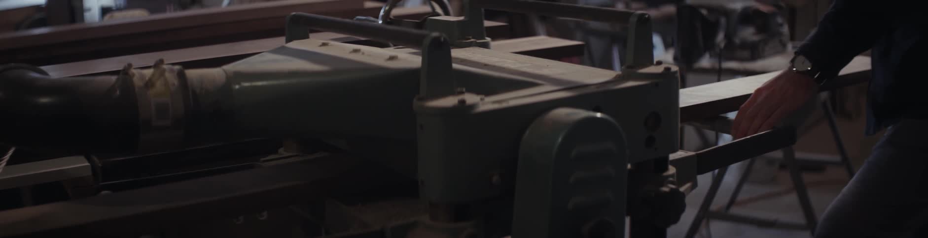 A piece of lumber is fed through a machine