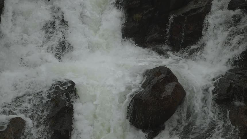 River water gushes over boulders and rocks