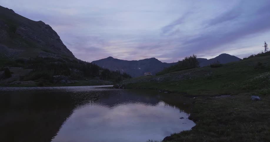 The lake is calm near the mountain