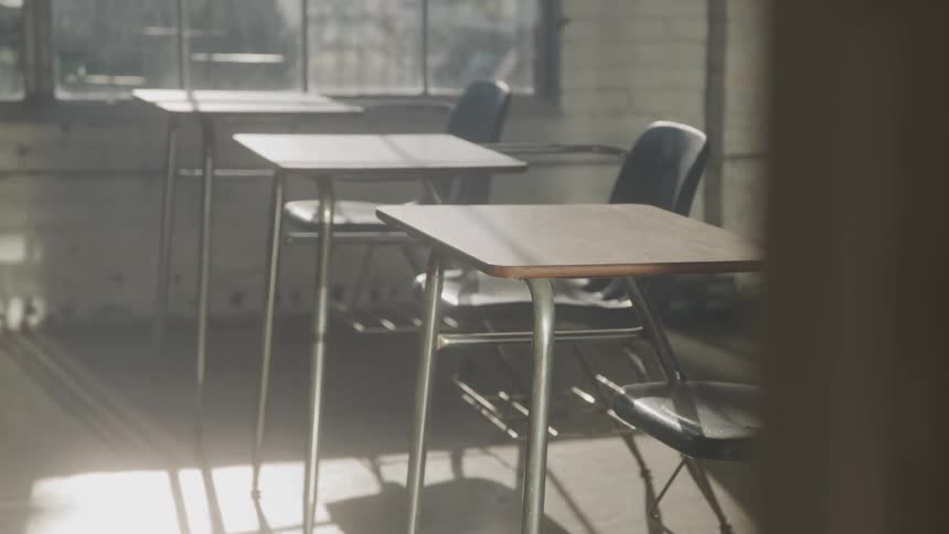 Empty student desks in a vacant classroom