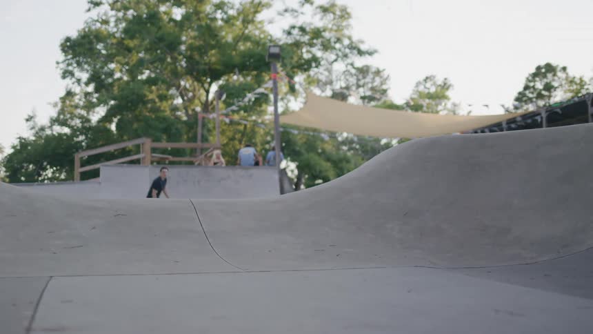 The teenager makes a jump in the skate park