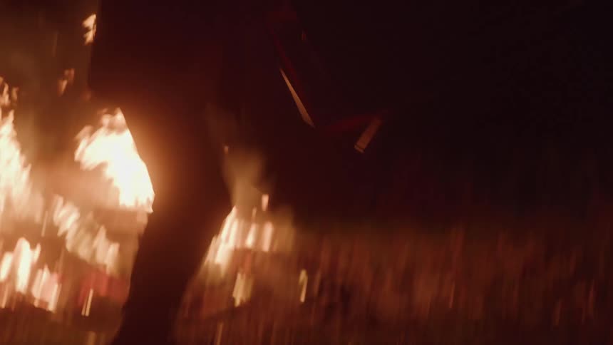 The man throws the chair into the fire in anger