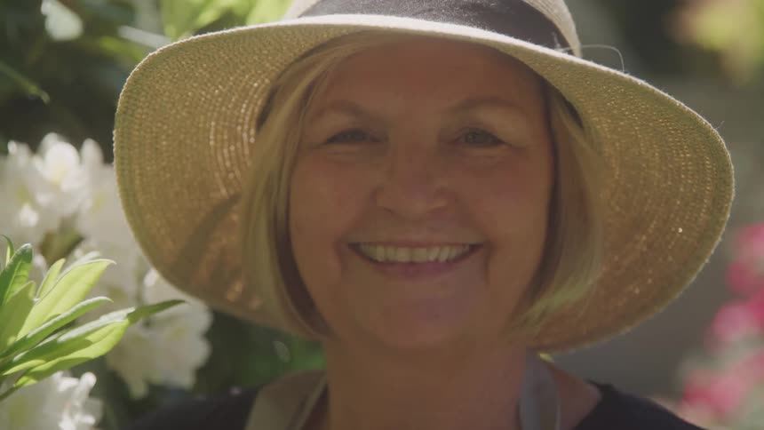 Close up portrait of a middle aged woman in a garden during daytime