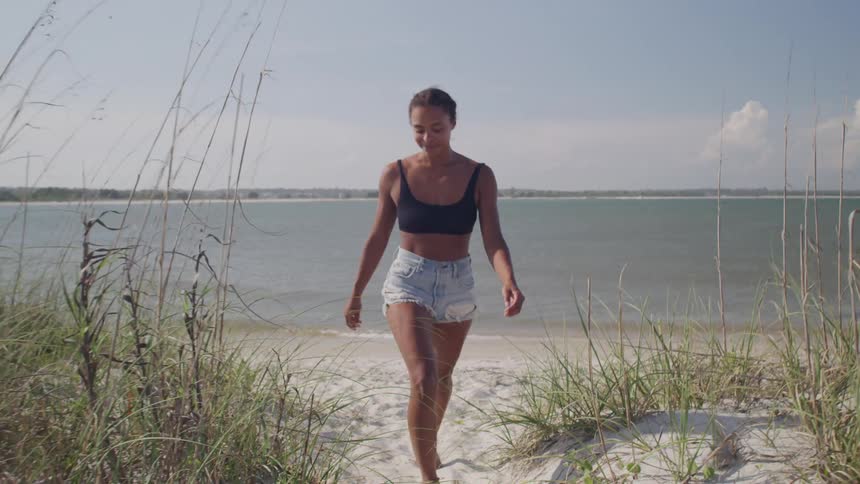 A woman walks on the beach