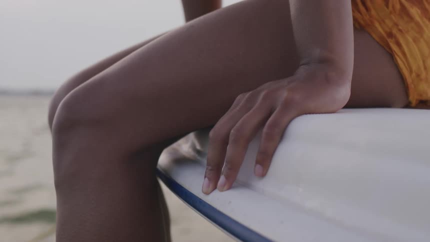 A woman rides on the side of the boat
