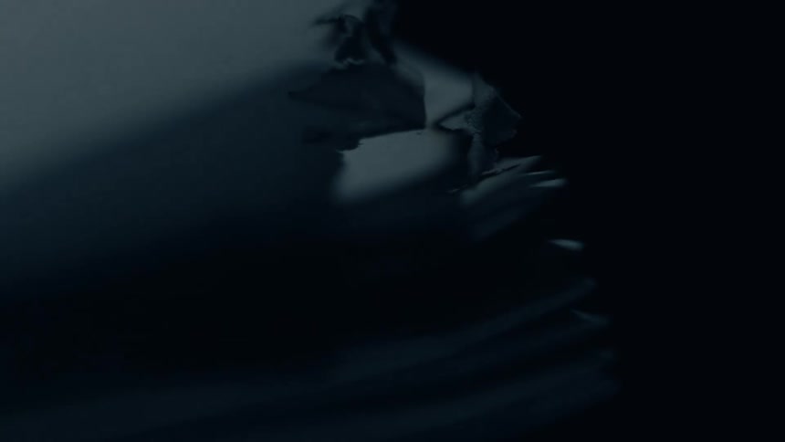 Burnt edges of stacked pages appear under soft light