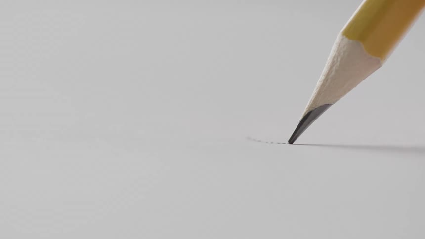 A sharpened yellow pencil makes its first faint mark on a clean white sheet of paper