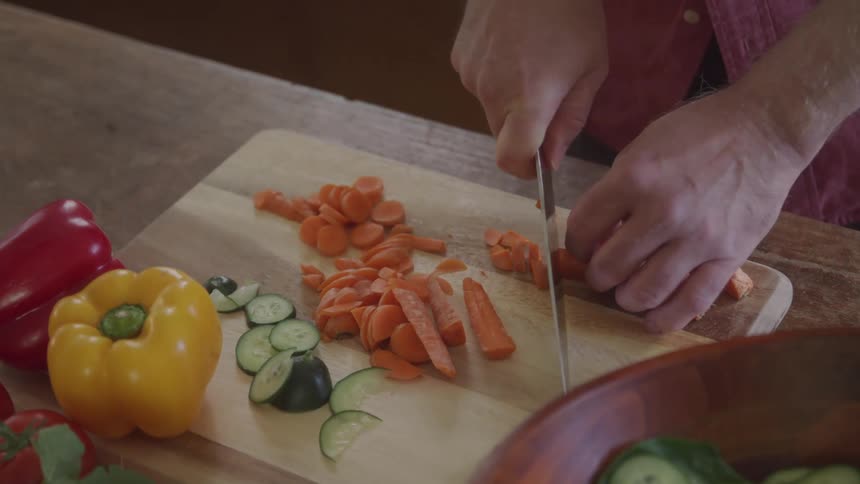 Person chopping carrots on a cutting board