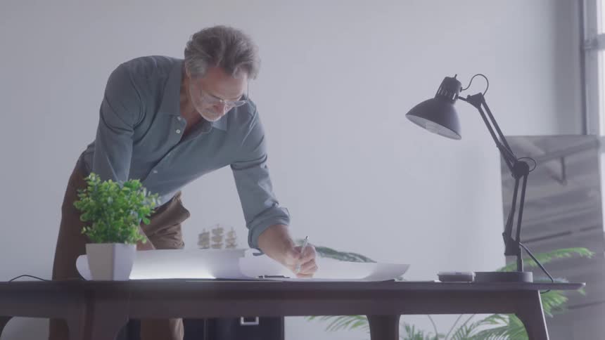 Man working on a project on top of an office desk