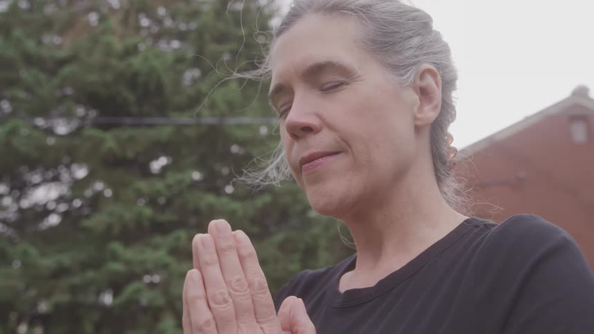 Woman meditating peacefully outdoors