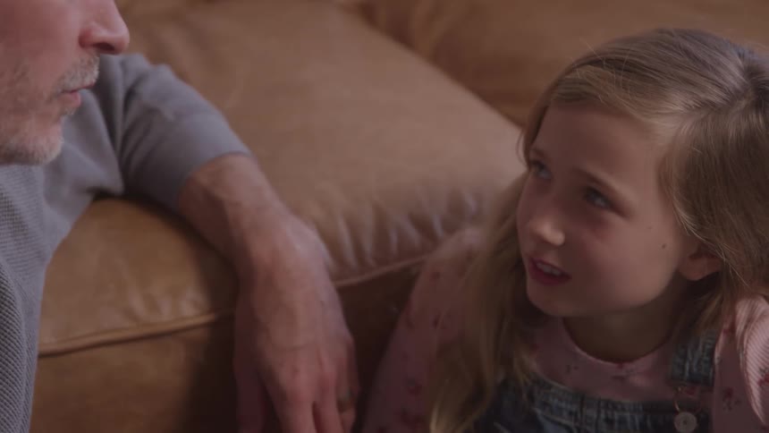 Father sitting hand in hand with his daughter talking