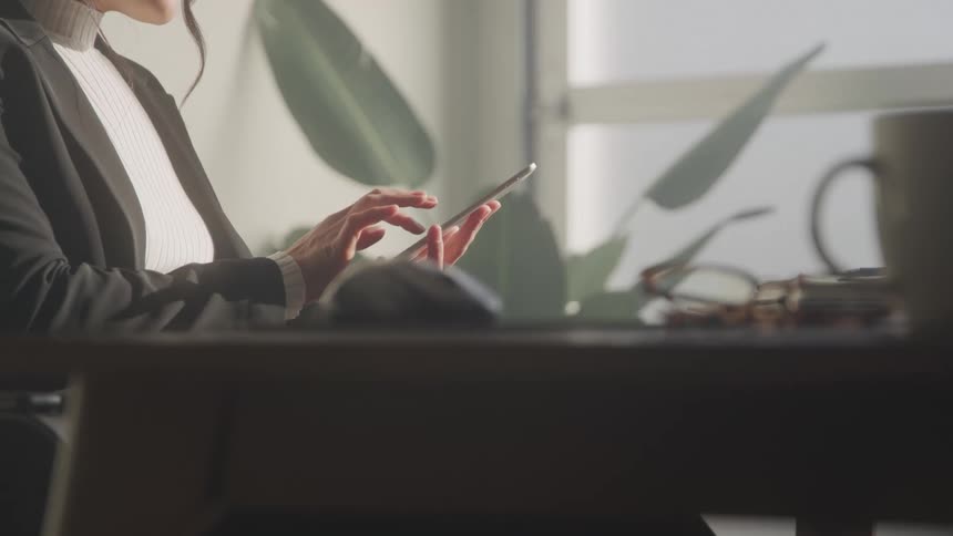 Woman sitting interacting with a smartphone
