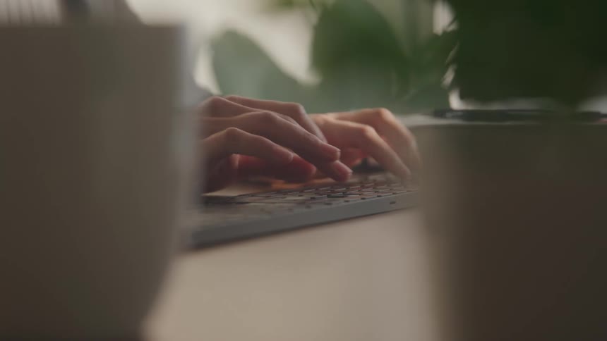 Pair of hands typing on a computer keyboard