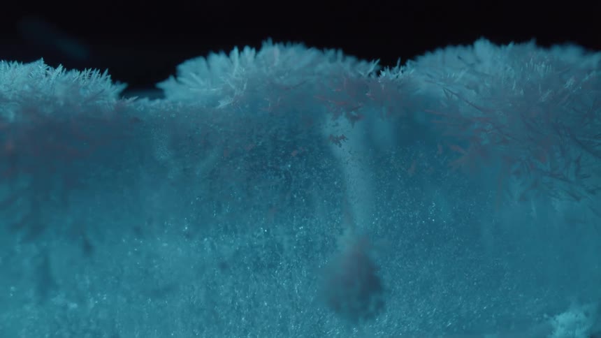 Dense ice crystals accumulate on the upper surface of a block