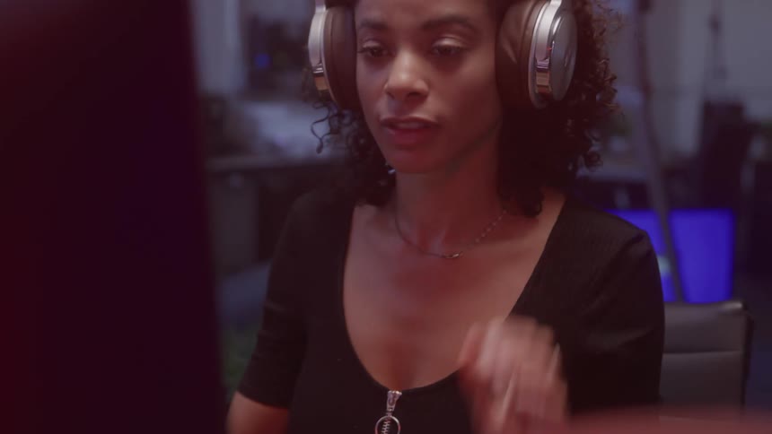 Woman sitting putting on headphones