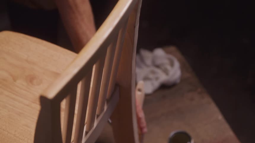 Staining a wood chair with a paint brush