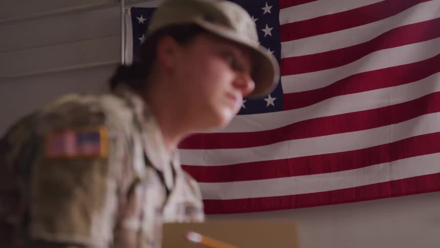 The soldier is writing with a pencil